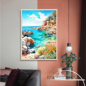 May include: A watercolor painting of a seascape with a rocky coastline, turquoise water, and orange flowers. The painting is framed in a light wood frame.