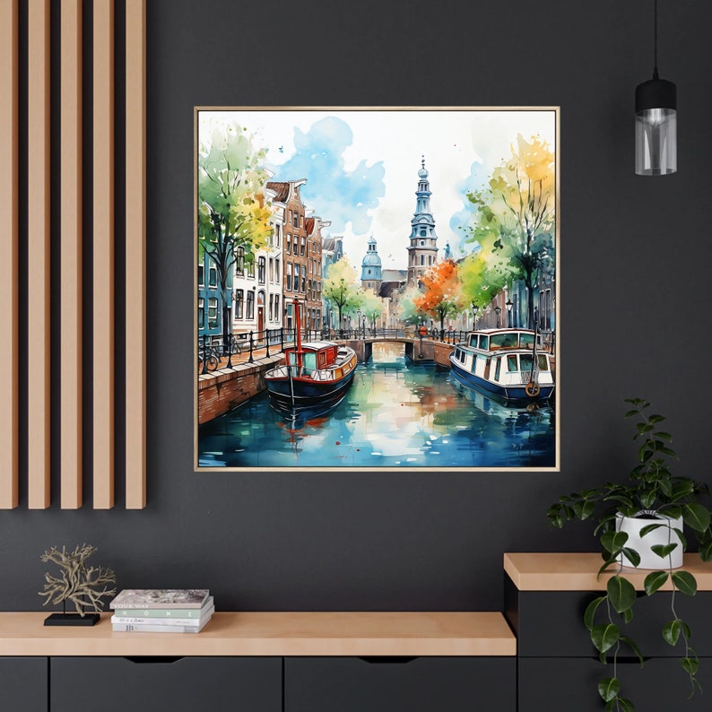 May include: Watercolor painting of a canal scene in a European city. The painting features a narrow canal with buildings lining both sides. There are two boats on the canal, one in the foreground and one in the background. The buildings are painted in a variety of colors, including red, yellow, and blue. The sky is a light blue with white clouds.