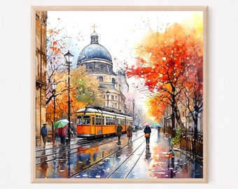 May include: A framed watercolor print depicting a city street scene with a bright orange tram on tracks, pedestrians holding umbrellas, and trees with vibrant autumn foliage. In the background, a large domed building stands under a bright sky.