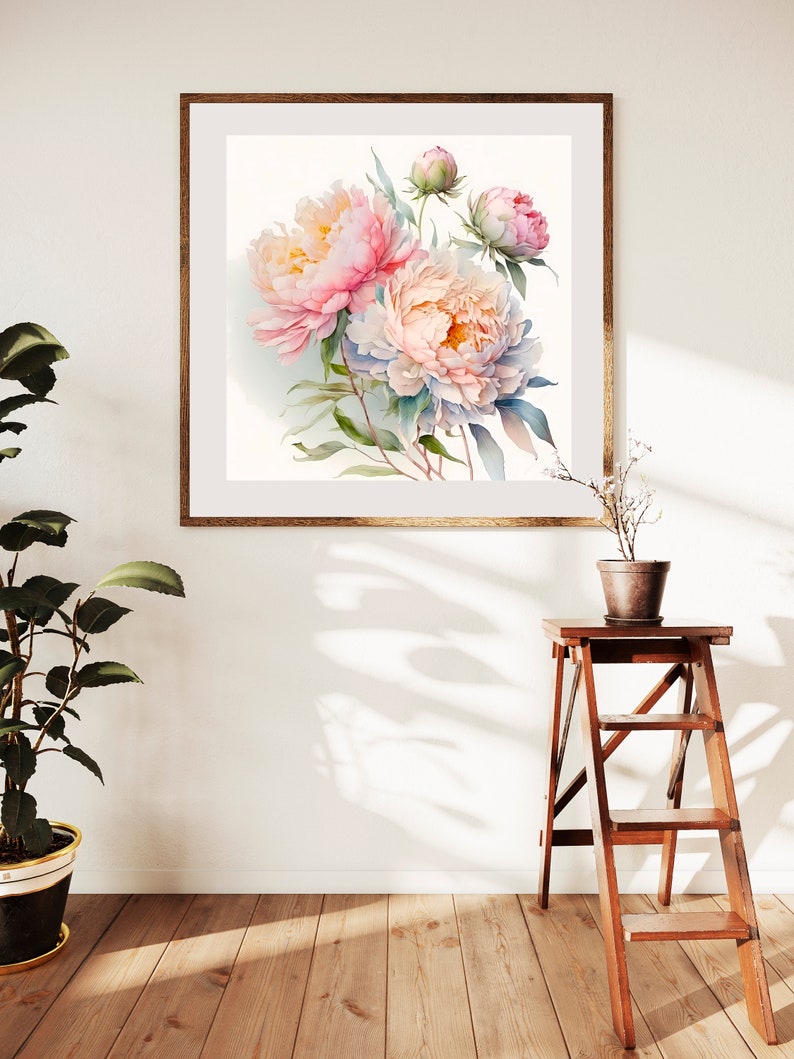 Pode incluir: Uma pintura de aquarela emoldurada de pe&ocirc;nias rosa e brancas com folhas verdes. A pintura est&aacute; em uma moldura de madeira clara e est&aacute; pendurada em uma parede branca.