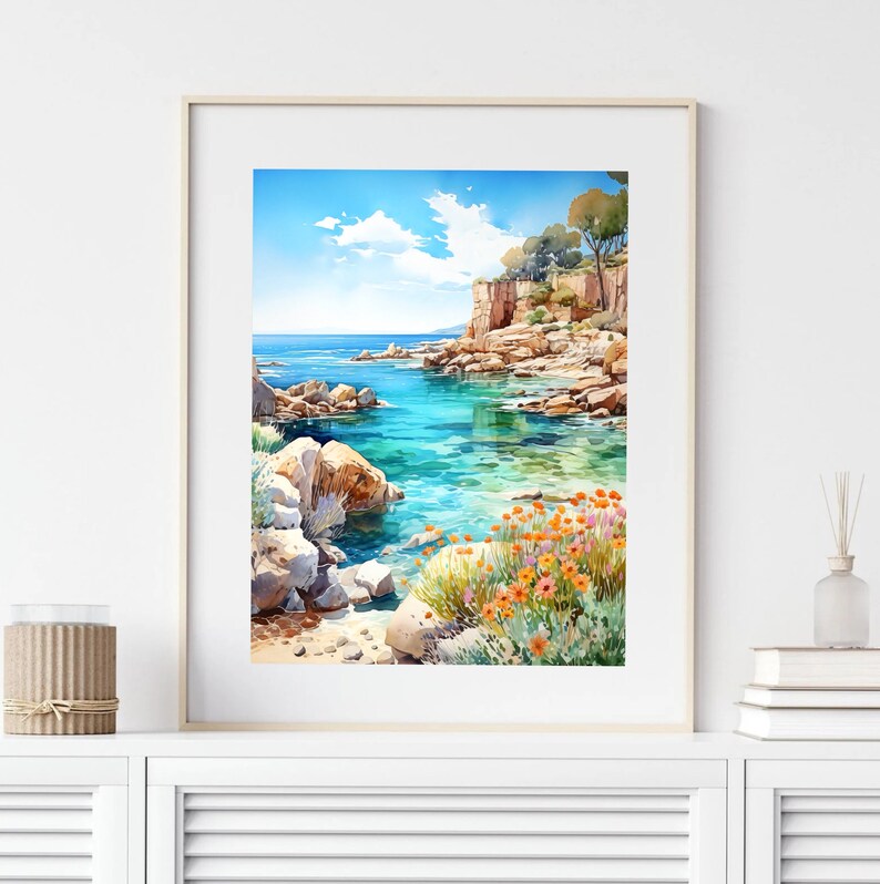 May include: A watercolor painting of a rocky coastline with turquoise water. The scene features a small cove with orange flowers growing on the rocks. The sky is blue with white clouds.