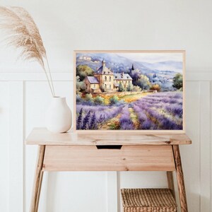 May include: A watercolor painting of a stone building with a lavender field in the foreground. The building has a pointed roof and is surrounded by trees. The lavender field is a vibrant purple and extends to the horizon.