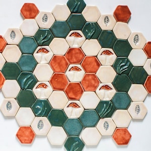 May include: A hexagonal tile mosaic with a repeating pattern of green, white, and orange tiles. Each tile features a raised design of a mushroom, leaf, or a cluster of grass.