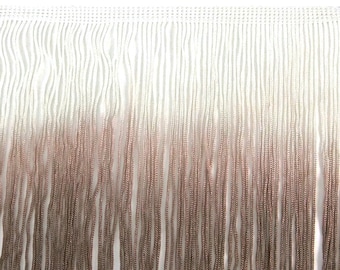 May include: White and brown ombre fringe trim. The fringe is made of a soft, silky material and is perfect for adding a touch of elegance to any project.