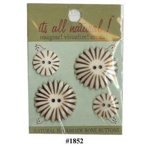 May include: A pack of four round, off-white bone buttons featuring brown radial stripes and two central holes. The packaging displays the text "its all natural! imagine! visualize! create!" and "NATURAL HANDMADE BONE BUTTONS" with the number #1852.