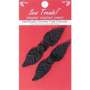 May include: Black handmade Chinese frog closures. The closures are leaf-shaped with intricate woven details. The product is packaged on a red card with the text "Sew Trendz!" and "Handmade Chinese Frog Closures".