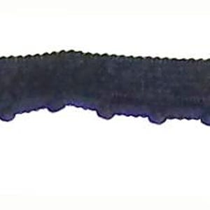May include: A black rubber strip with a series of small, evenly spaced, rounded protrusions along one edge. The strip has a slightly uneven surface and a subtle curve.