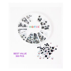 May include: A white circular plastic storage wheel containing 300 pieces of assorted small round rhinestones in various sizes. The container features the brand name HOTEE in the center. A collection of loose rhinestones is scattered below the wheel.