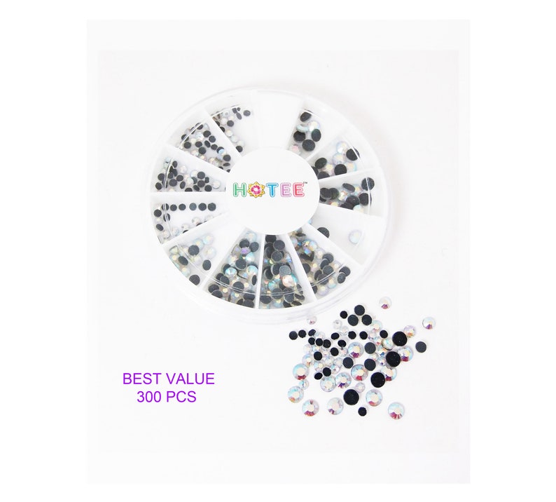 May include: A white circular plastic storage wheel containing 300 pieces of assorted small round rhinestones in various sizes. The container features the brand name HOTEE in the center. A collection of loose rhinestones is scattered below the wheel.