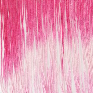 May include: A close-up of a pink fringe trim with a gradient effect. The top is fuchsia, fading to a lighter pink and then white. The trim is made of vertical strands, ideal for craft projects or garment embellishment.