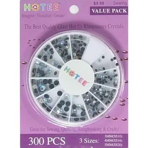 May include: A circular white plastic storage wheel containing assorted clear and black hot fix glass rhinestones. The packaging is purple with the text HOTEE, The Best Quality Glass Hot fix Rhinestones Crystals, 300 PCS, and 3 sizes: 3MM, 4MM, 5MM.