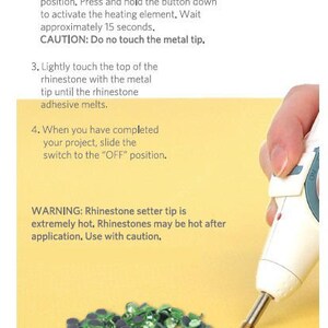 May include: A white and teal handheld rhinestone setter tool with a metal tip, shown applying heat to a small green rhinestone. The image includes instructional text: 1. Set a rhinestone in place, 2. Slide power switch to ON, 3. Touch tip to rhinestone, 4. Slide switch to OFF.