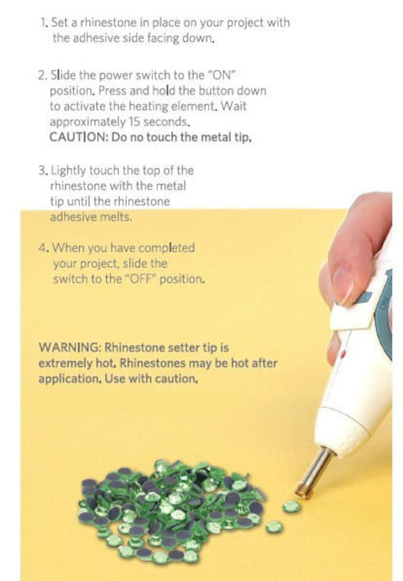 May include: A white and teal handheld rhinestone setter tool with a metal tip, shown applying heat to a small green rhinestone. The image includes instructional text: 1. Set a rhinestone in place, 2. Slide power switch to ON, 3. Touch tip to rhinestone, 4. Slide switch to OFF.
