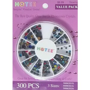 May include: A circular white plastic organizer case filled with 300 multi-colored glass hot fix rhinestones in three sizes: 3mm (SS10), 4mm (SS16), and 5mm (SS20). The packaging is purple with the text HOTEE, Imagine! Visualize! Create!, and Value Pack.
