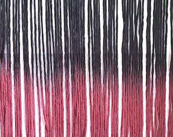 May include: Black and burgundy ombre fringe trim. The fringe is made of thin strands of yarn that are tied together at the top. The fringe is about 1 inch long.