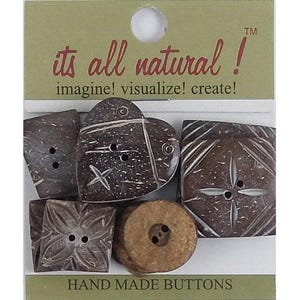 May include: A set of five dark brown buttons in various shapes including a heart, square, and circle, attached to a card labelled its all natural! imagine! visualize! create! and HAND MADE BUTTONS. The buttons feature carved patterns and two holes.