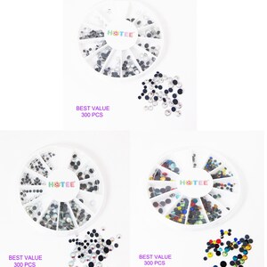 May include: Three circular white plastic organizers containing assorted small round rhinestones in clear, black, and multi-colored varieties. Each organizer features the brand name HOTEE in the center and the text BEST VALUE 300 PCS printed below.