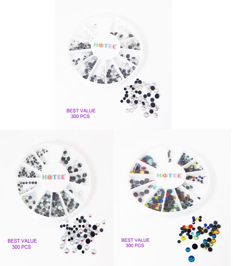 May include: Three circular white plastic organizers containing assorted small round rhinestones in clear, black, and multi-colored varieties. Each organizer features the brand name HOTEE in the center and the text BEST VALUE 300 PCS printed below.