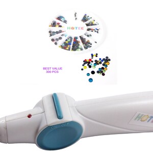 May include: A white hotfix applicator tool with a blue switch and a metal tip, accompanied by a circular white container holding 300 multicolored rhinestones. The text HOTEE is printed on the tool and the container, with BEST VALUE 300 PCS text.