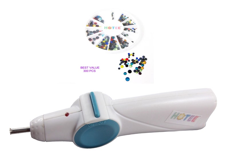 May include: A white hotfix applicator tool with a blue switch and a metal tip, accompanied by a circular white container holding 300 multicolored rhinestones. The text HOTEE is printed on the tool and the container, with BEST VALUE 300 PCS text.