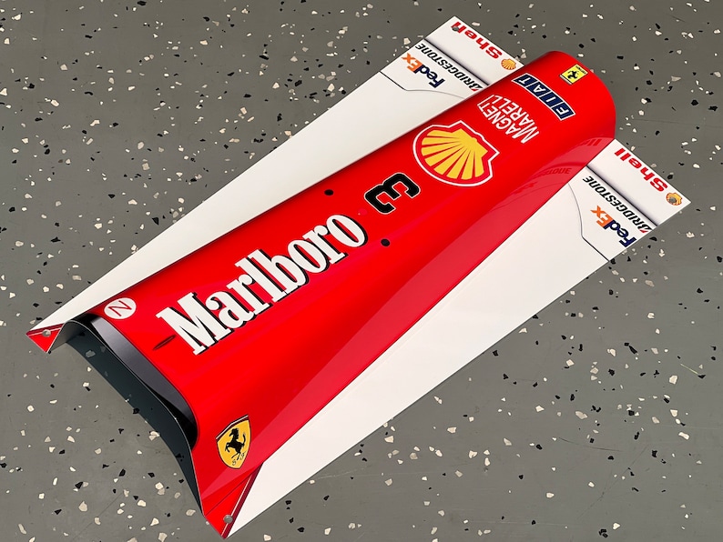 May include: A red and white Formula 1 race car nose cone with the Marlboro logo, the number 3, and sponsors like FedEx, Bridgestone, and Shell.