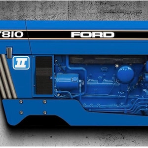 May include: Blue tractor engine cover with the text "7810 FORD" in white. The cover has black and gold stripes and a white logo with a blue "II" inside. The engine components are visible.