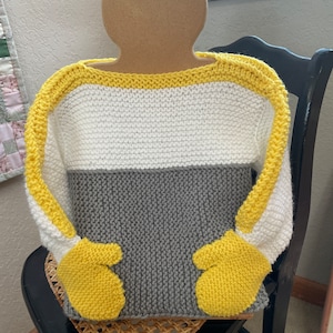 May include: A knitted sweater with yellow, white, and gray stripes. The sweater has attached mittens.