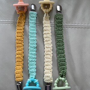 Baby pacifier clip- 100% cotton- a loop for easy removal of the pacifier for cleaning at one end and a strong metal clip at the other end.