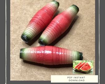 May include: Three watermelon-themed paper beads, each with a red and green striped pattern. The beads are arranged on a brown surface. The image also includes a smaller image of three slices of watermelon on a plate.