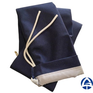 May include: A navy blue drawstring bag with a white drawstring. The bag has a light gray lining.