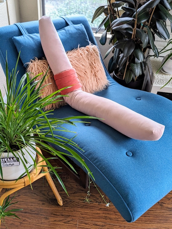 A Comfy Couch With Pillows Surrounded By Houseplants Stock Photo