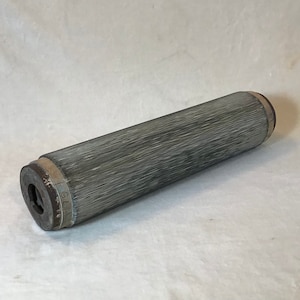 May include: A gray cylindrical filter with a brown end cap. The filter has a textured surface and is approximately 10 inches long.