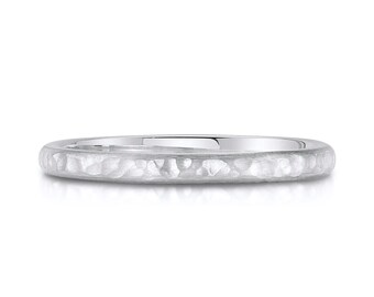 May include: A simple silver wedding band with a hammered texture.