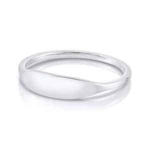 May include: A silver ring with a smooth, oval-shaped band.