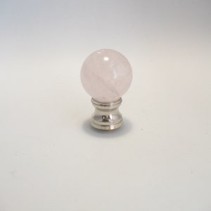 May include: A pink rose quartz lamp finial with a silver base.