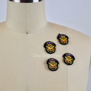 May include: Four black embroidered patches with a gold eagle and red, white, and blue accents. The patches are on a light beige fabric background.