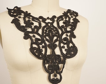 May include: Black lace collar with a delicate floral design. The collar is made of a soft, lightweight fabric and is perfect for adding a touch of elegance to any outfit.