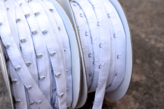 White with Silver Hook and Loop Trim Fixed on Cotton  1" Spacing.