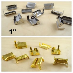 May include: Two sets of metal slider buckles, one set is silver and the other is gold. The silver set is labeled "1" with a quotation mark. The buckles are approximately 1 inch in size.