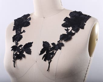 May include: Black floral lace applique with a delicate design of roses and leaves. This applique is perfect for adding a touch of elegance to any garment or craft project.