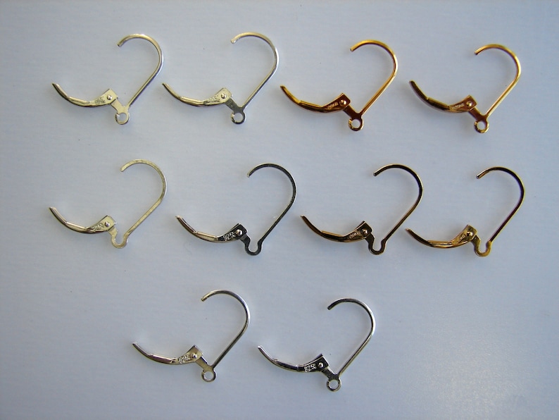 May include: A set of 10 earring hooks, with 4 silver, 4 gold, and 2 silver hooks. The hooks are all the same size and shape, with a small loop at the top and a clasp at the bottom.