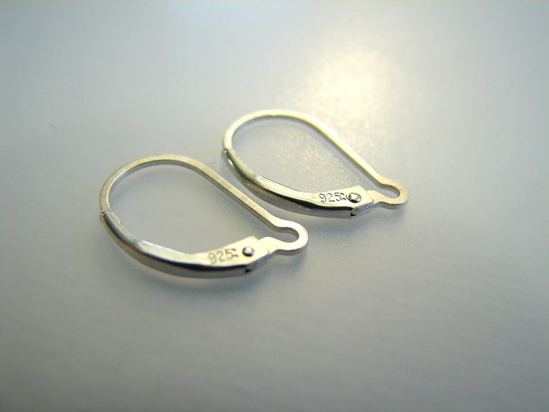 May include: Two silver earring hooks, each stamped with 925.