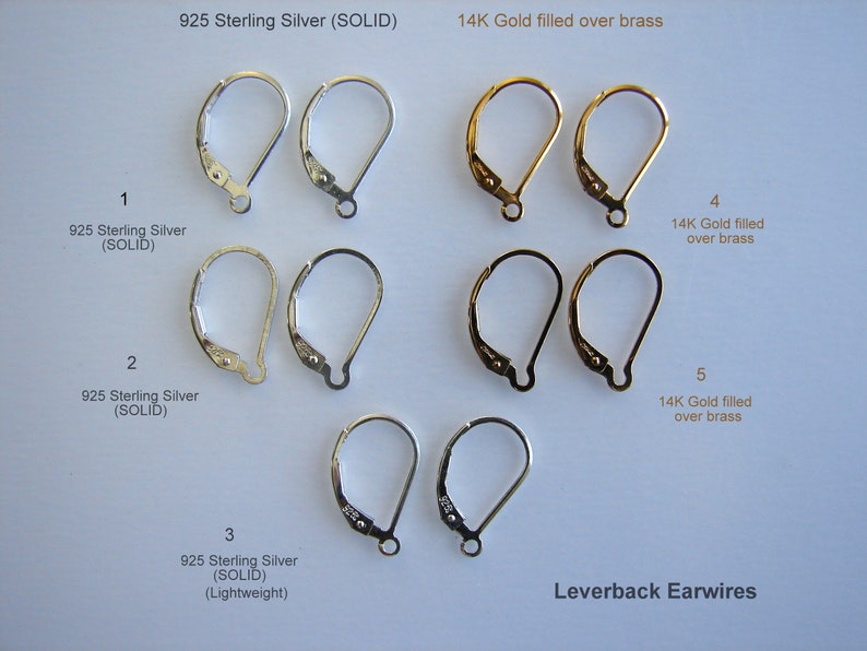 May include: An assortment of leverback earwires in sterling silver and 14k gold filled over brass. The earwires are displayed in pairs, numbered 1 through 5. All the earwires are the same size and shape, but they are made of different materials. Leverback earwires are a popular choice for earrings because they are secure and comfortable to wear.