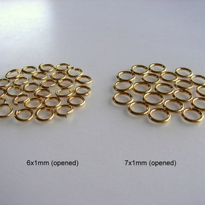 May include: Two groups of gold jump rings, one group of 6 mm rings and one group of 7 mm rings. Both groups are arranged in a circular pattern and are open.