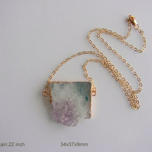 May include: A gold chain necklace with a large, irregularly shaped, light purple and green agate pendant. The pendant measures 34x37x9mm. The chain is 22 inches long. Lot 1.