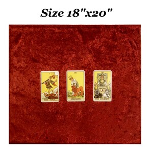 May include: A red velvet tarot cloth measuring 18 inches by 20 inches. Three tarot cards are laid out on the cloth: The Fool, Strength, and The Chariot.