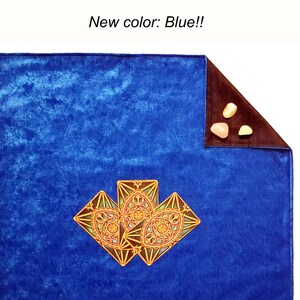 May include: Blue velvet tarot cloth with three gold tarot cards featuring intricate designs. The cloth has a brown velvet border.