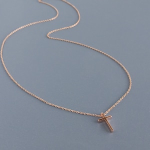 Very dainty rose gold cross on a simple chain of 14k rose gold.