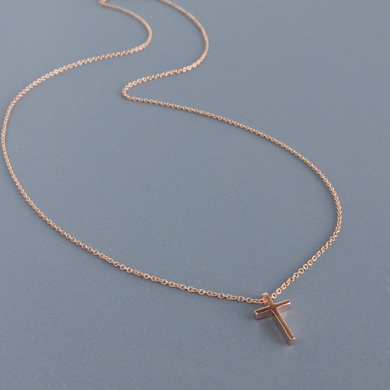 Very dainty rose gold cross on a simple chain of 14k rose gold.