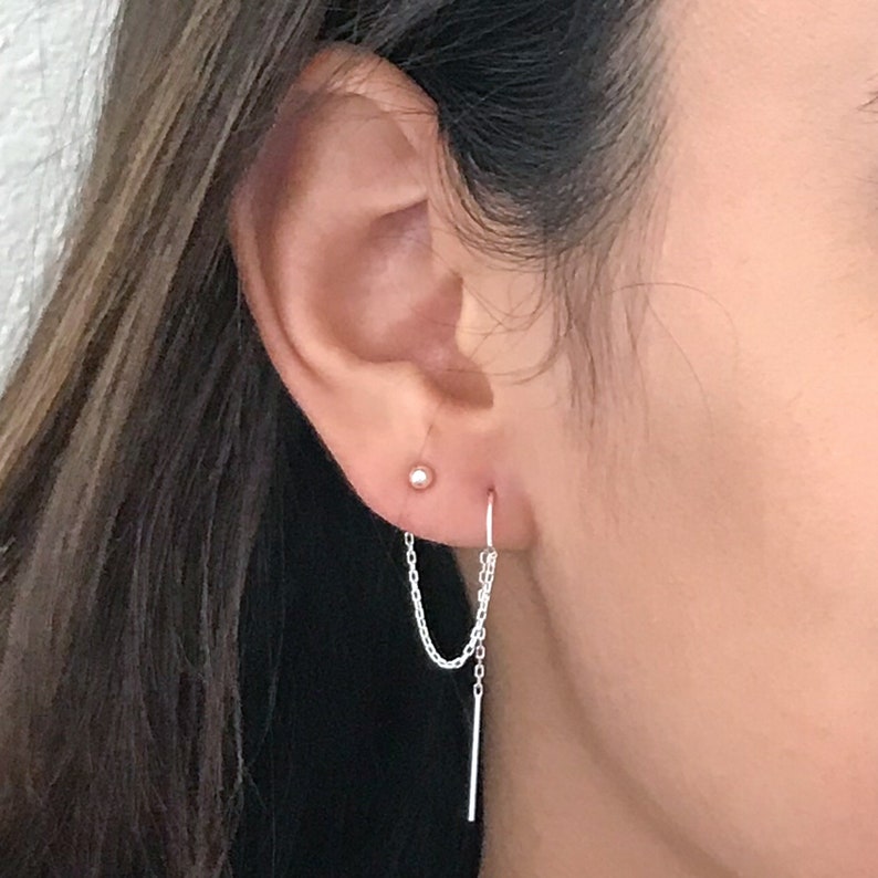 Shown here on a model in sterling silver.  These earrings are for women with 2 piercings in each earlobe.  One above the other.  The earring is one small 3mm ball stud connected to a threader earring.